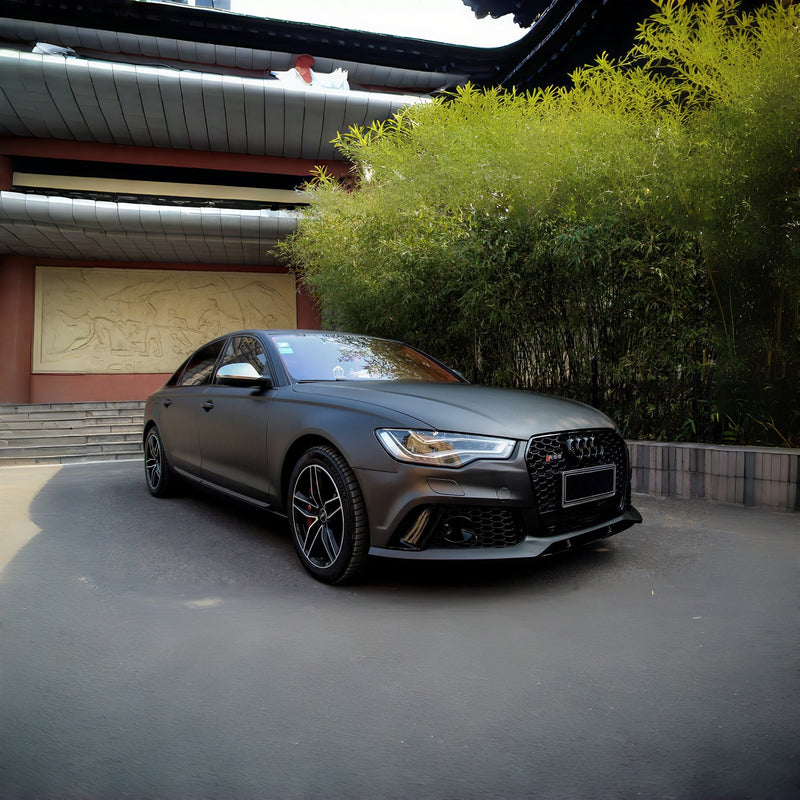 Matte-black finished sedan in a workshop, used as a finish illustration rather than a self-healing test