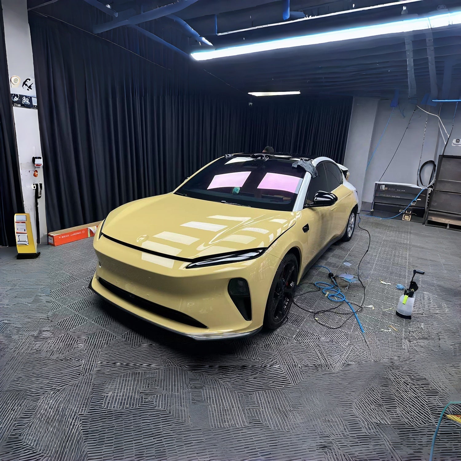Yellow finished car in a controlled installation studio, used as a finish illustration rather than yellowing evidence