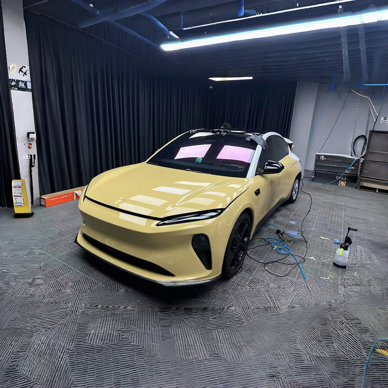 Yellow finished car in a controlled installation studio, used as a finish illustration rather than yellowing evidence