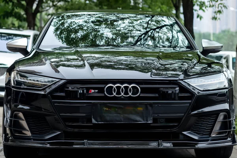 Black Audi viewed from the front with bumper, hood and side panels visible