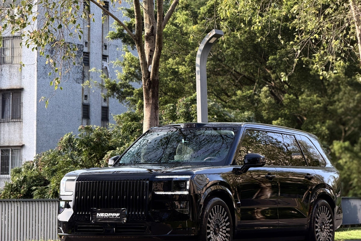 NEOPPF Super Black SUV viewed outdoors from the front three-quarter angle
