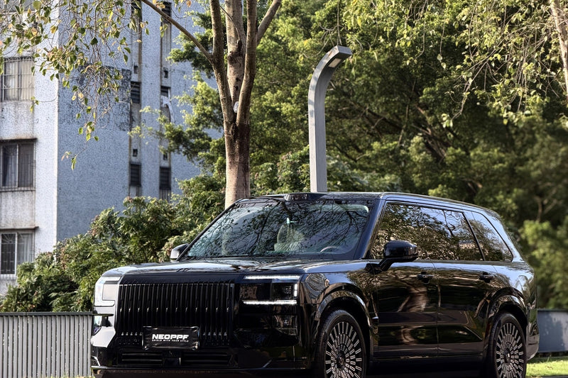 NEOPPF Super Black SUV viewed outdoors from the front three-quarter angle