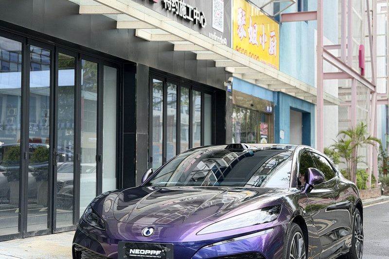 Purple NEOPPF media vehicle viewed from the front quarter with panel transitions visible