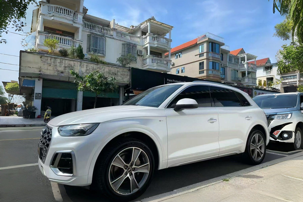White NEOPPF media SUV in a street setting, illustrating a full-vehicle view for a white film discussion