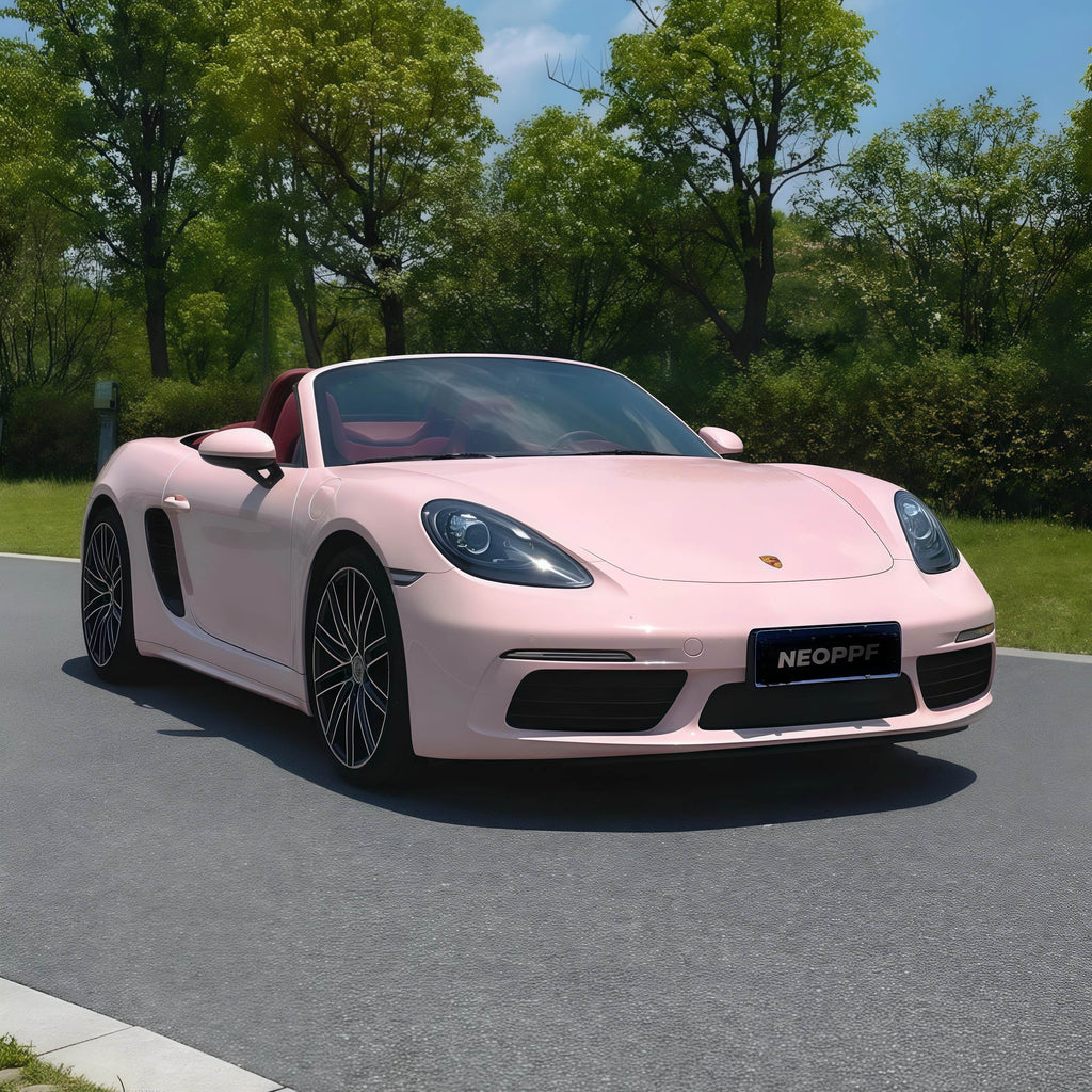 A sports car with Shell Pink paint protection film colored wrap is parking in the garage
