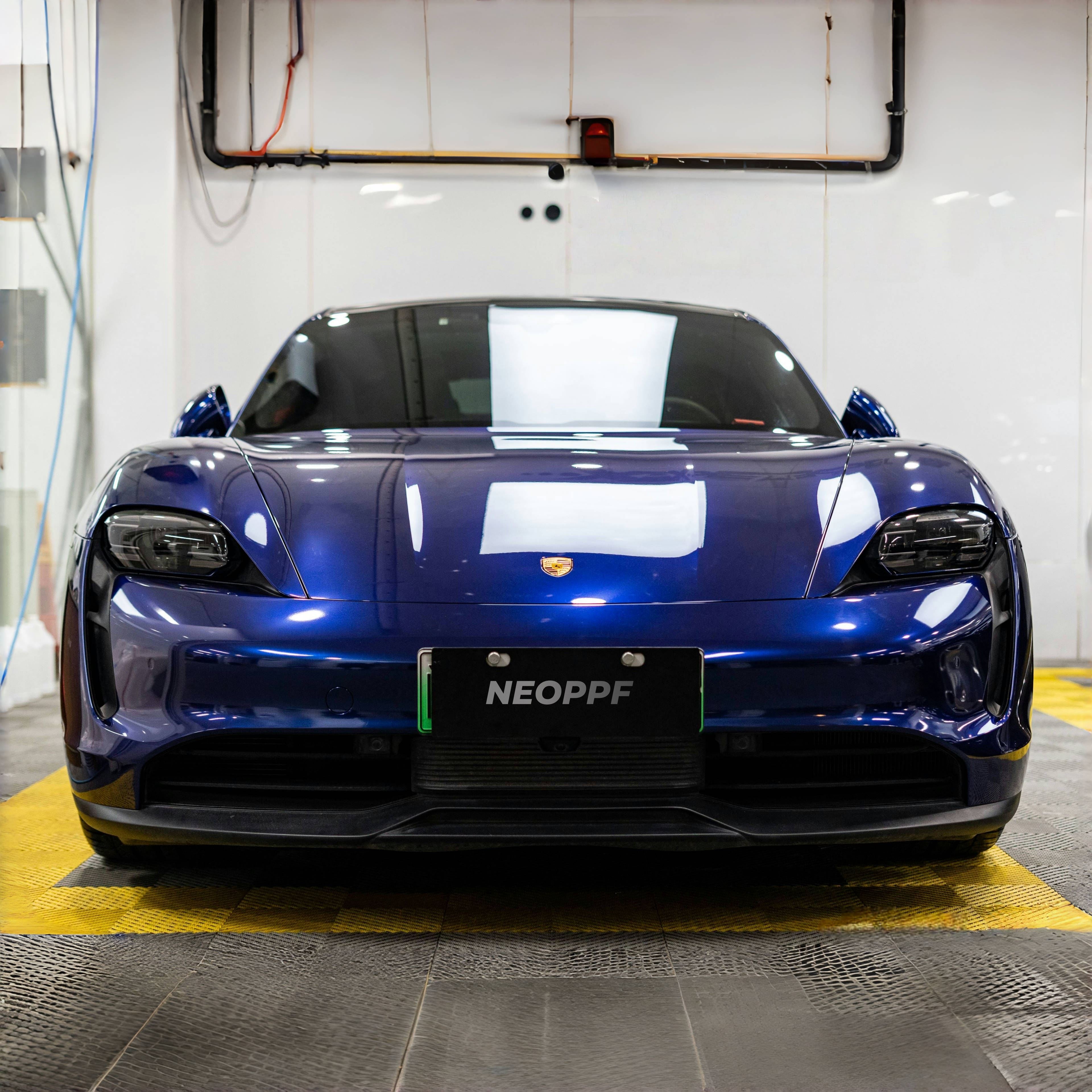 A sports car with Gentian Blue paint protection film colored wrap is parking in the garage