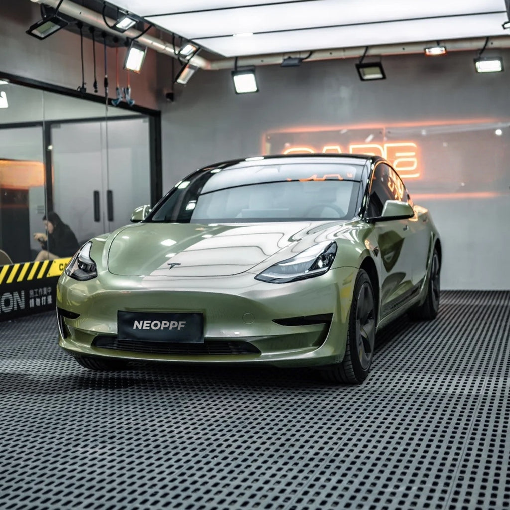 A sports car with Alpine Green paint protection film colored wrap is parking in the garage