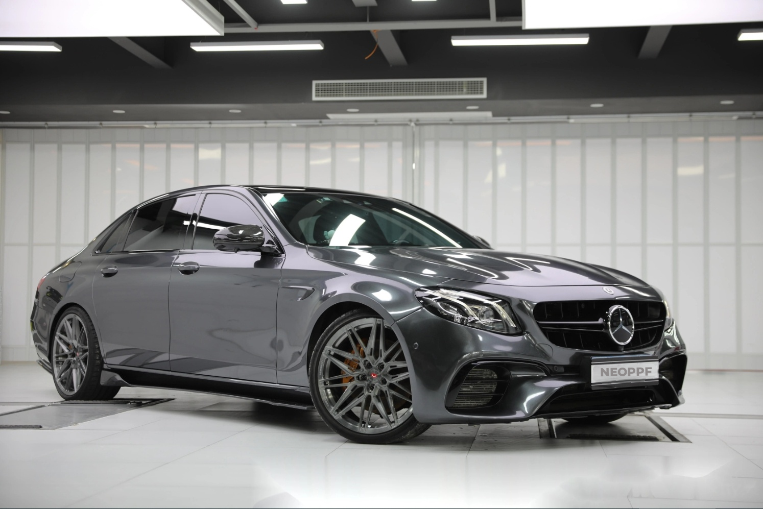 A sports car with Coal Gray paint protection film colored wrap is parking in the garage