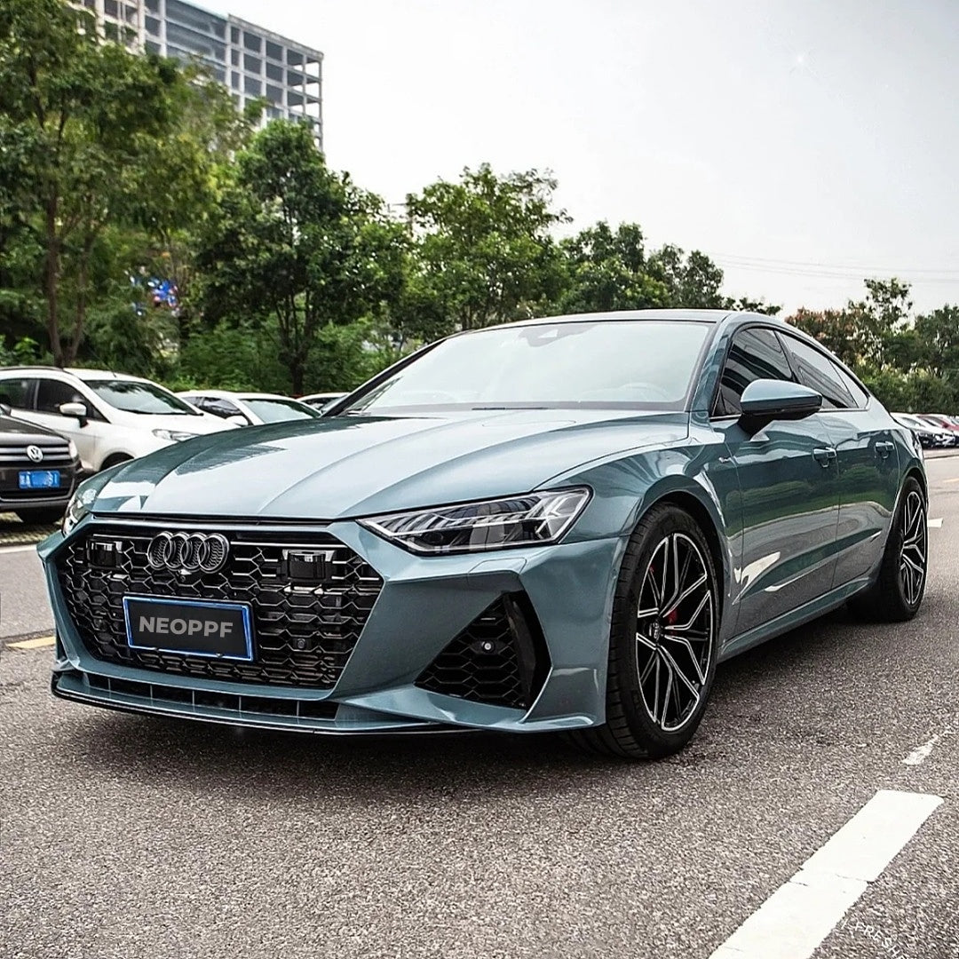 A sports car with Eucalyptus Blue paint protection film colored wrap is parking in the garage