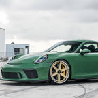 A sports car with Onium Green paint protection film colored wrap is parking in the garage