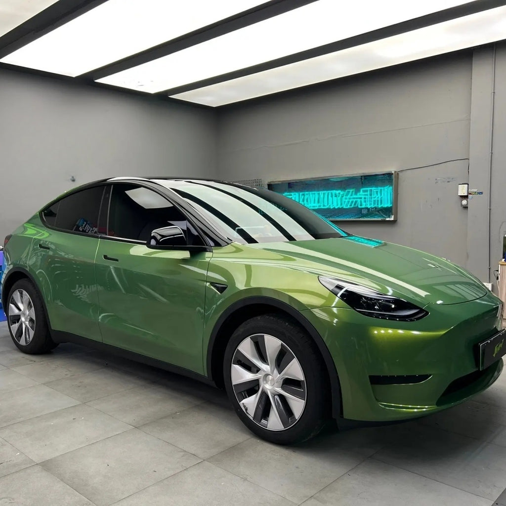 A sports car with Rainbow Emerald paint protection film colored wrap is parking in the garage