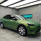 A sports car with Rainbow Emerald paint protection film colored wrap is parking in the garage