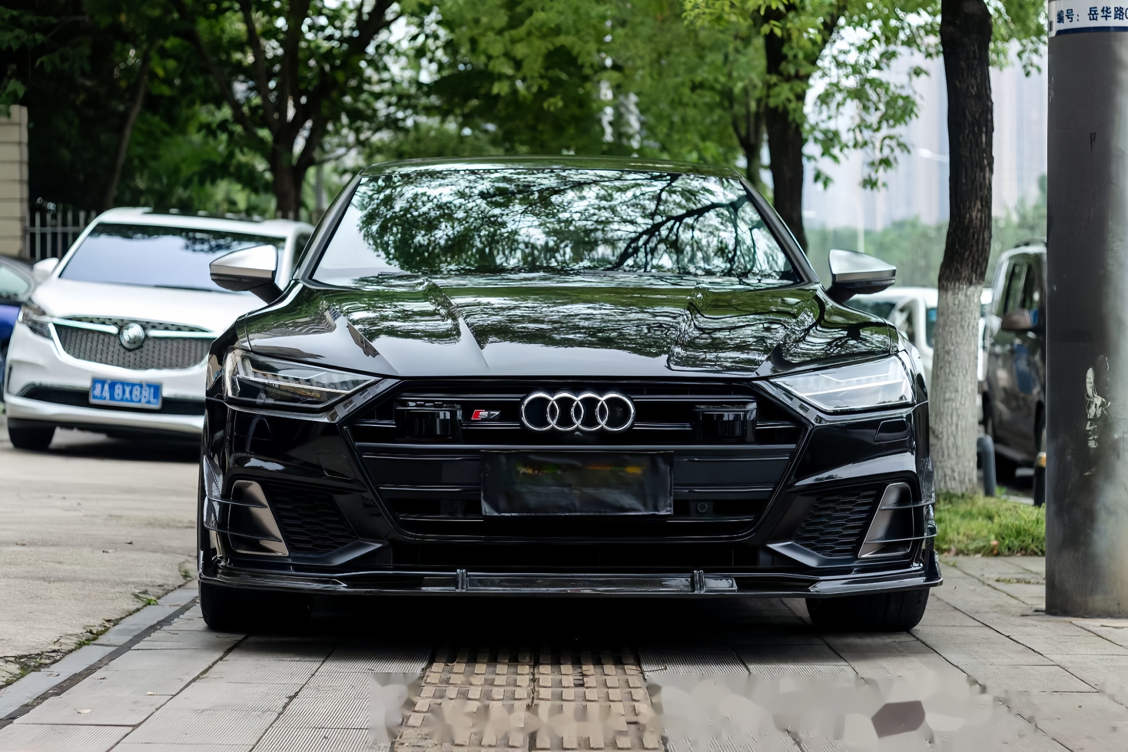 A sports car with Obsidian Black paint protection film colored wrap is parking in the garage