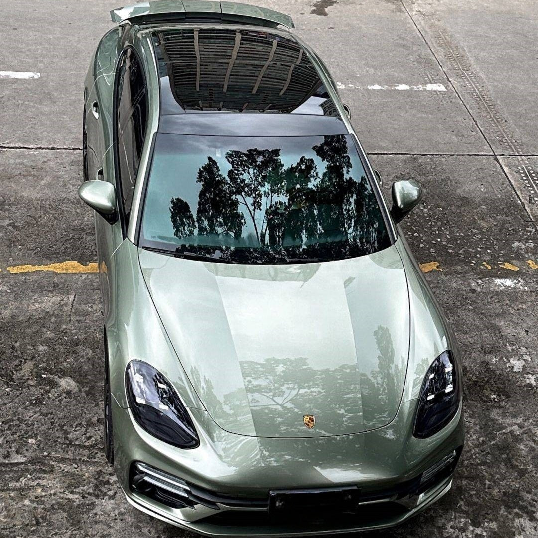 A sports car with Aventurine Green paint protection film colored wrap is parking in the garage