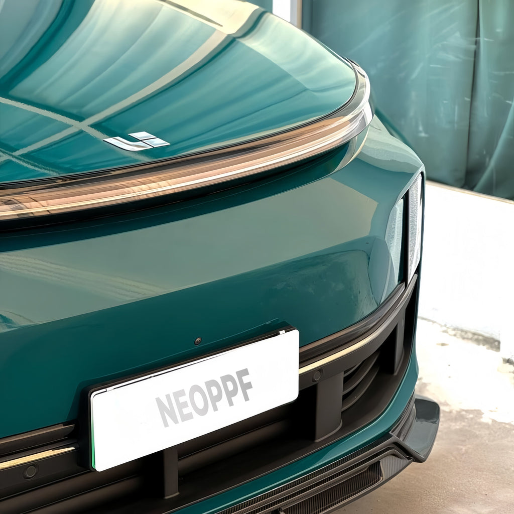 A sports car with Green Hell paint protection film colored wrap is parking in the garage