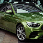 A sports car with Mamba Green paint protection film colored wrap is parking in the garage