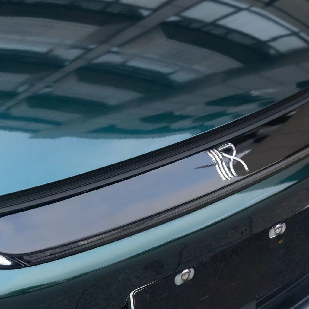 A sports car with Verdant Green paint protection film colored wrap is parking in the garage