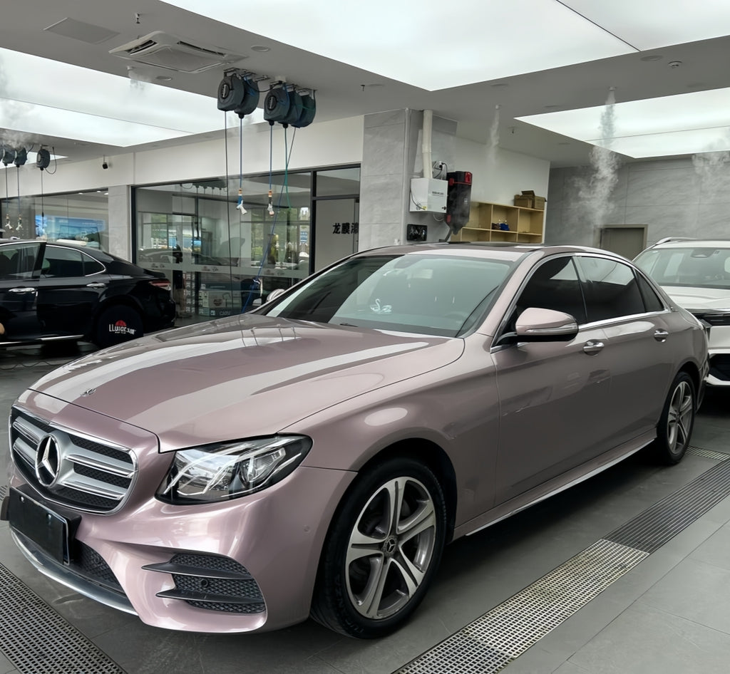 A sports car with Iced Berry Pink paint protection film colored wrap is parking in the garage