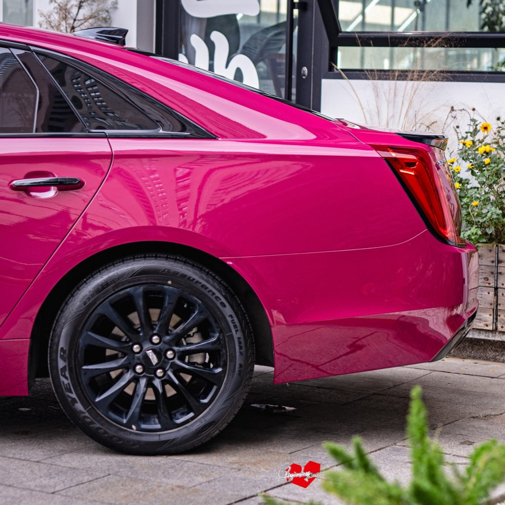 A sports car with Starlight Ruby Red paint protection film colored wrap is parking in the garage