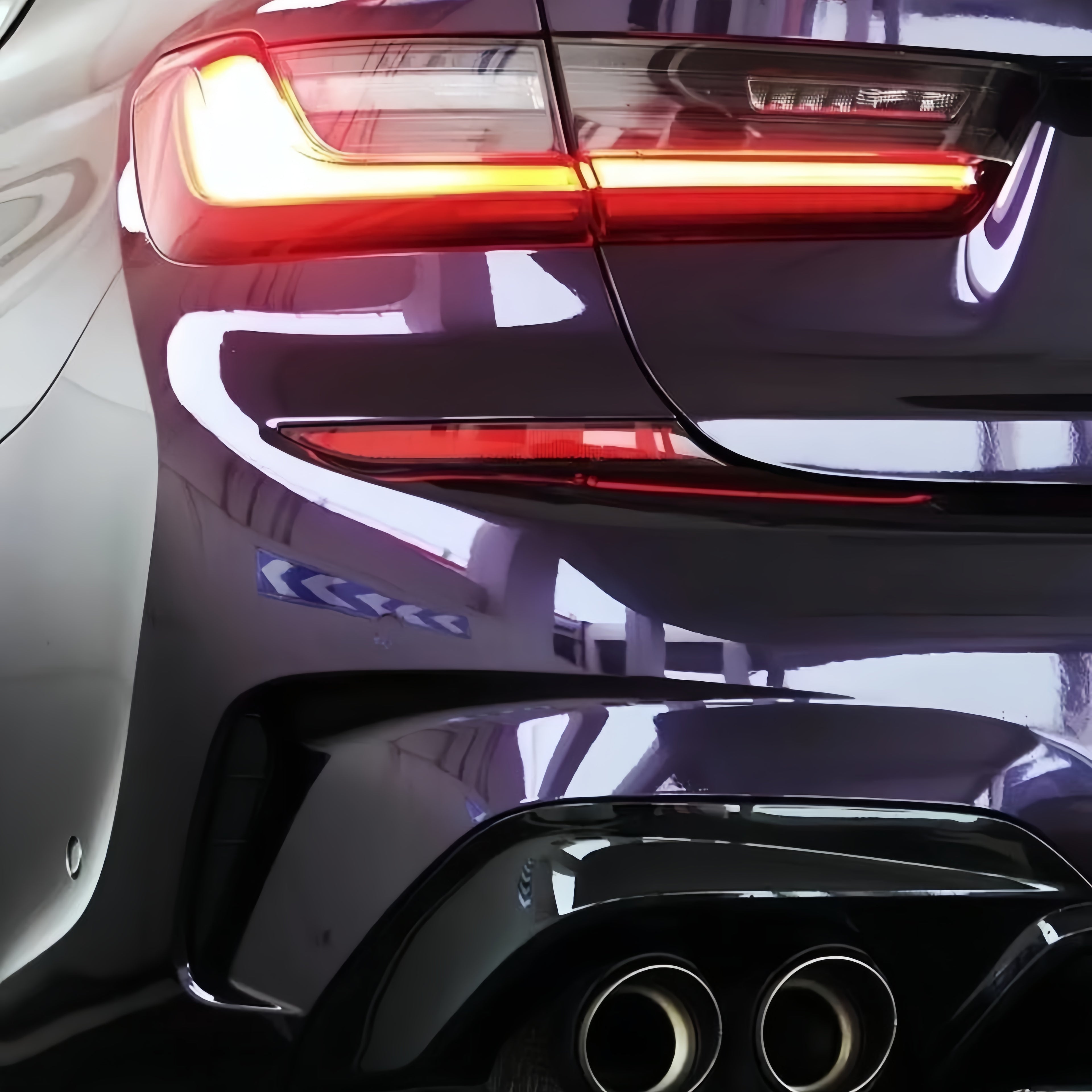 A sports car with Black Charm Purple paint protection film colored wrap is parking in the garage