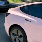 A sports car with Shell Pink paint protection film colored wrap is parking in the garage