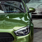A sports car with Mamba Green paint protection film colored wrap is parking in the garage