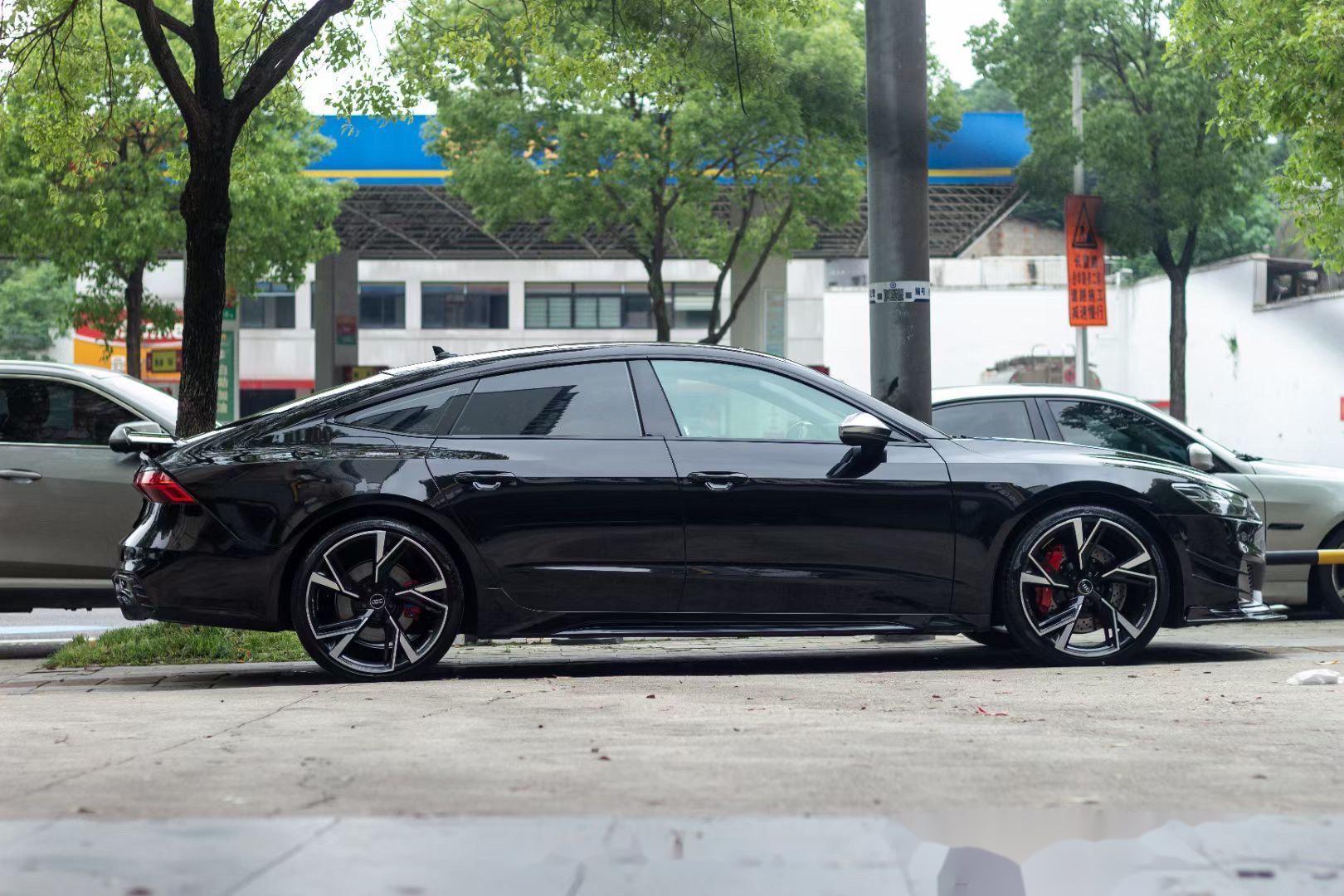 A sports car with Obsidian Black paint protection film colored wrap is parking in the garage