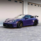 A sports car with GT Violet paint protection film colored wrap is parking in the garage