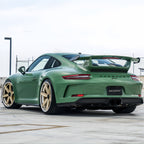 A sports car with Onium Green paint protection film colored wrap is parking in the garage