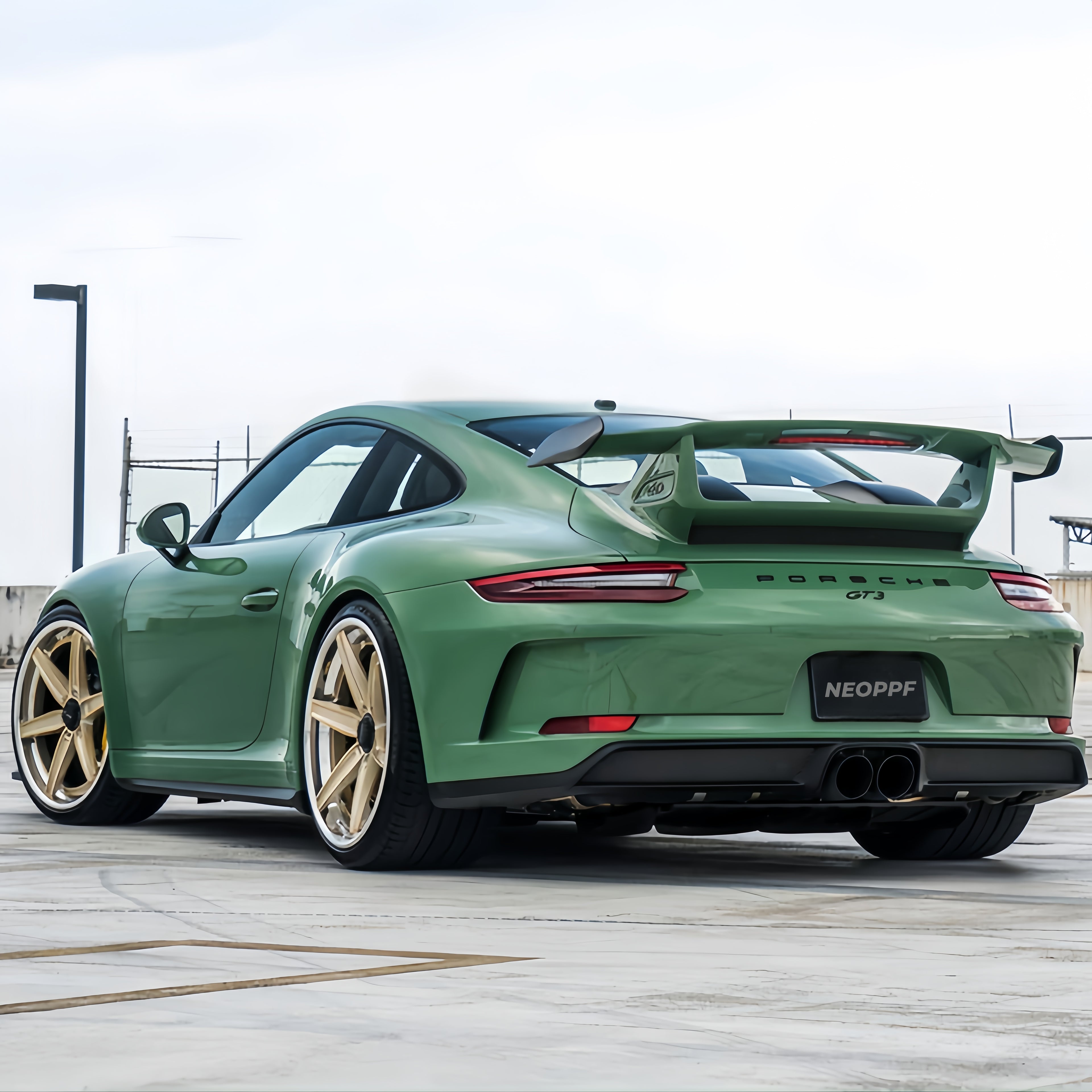 A sports car with Onium Green paint protection film colored wrap is parking in the garage