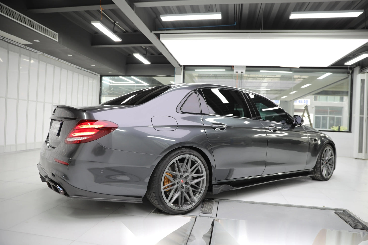 A sports car with Coal Gray paint protection film colored wrap is parking in the garage