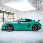 A sports car with Retro Green paint protection film colored wrap is parking in the garage