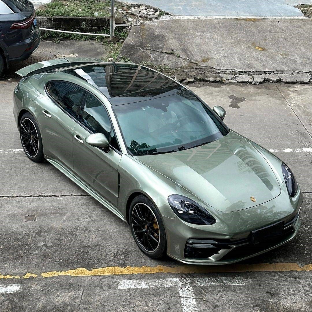 A sports car with Aventurine Green paint protection film colored wrap is parking in the garage
