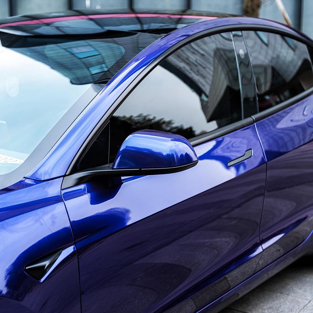 A sports car with Cobalt Blue Metallic paint protection film colored wrap is parking in the garage