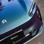 A sports car with Diamond Aurora Green paint protection film colored wrap is parking in the garage