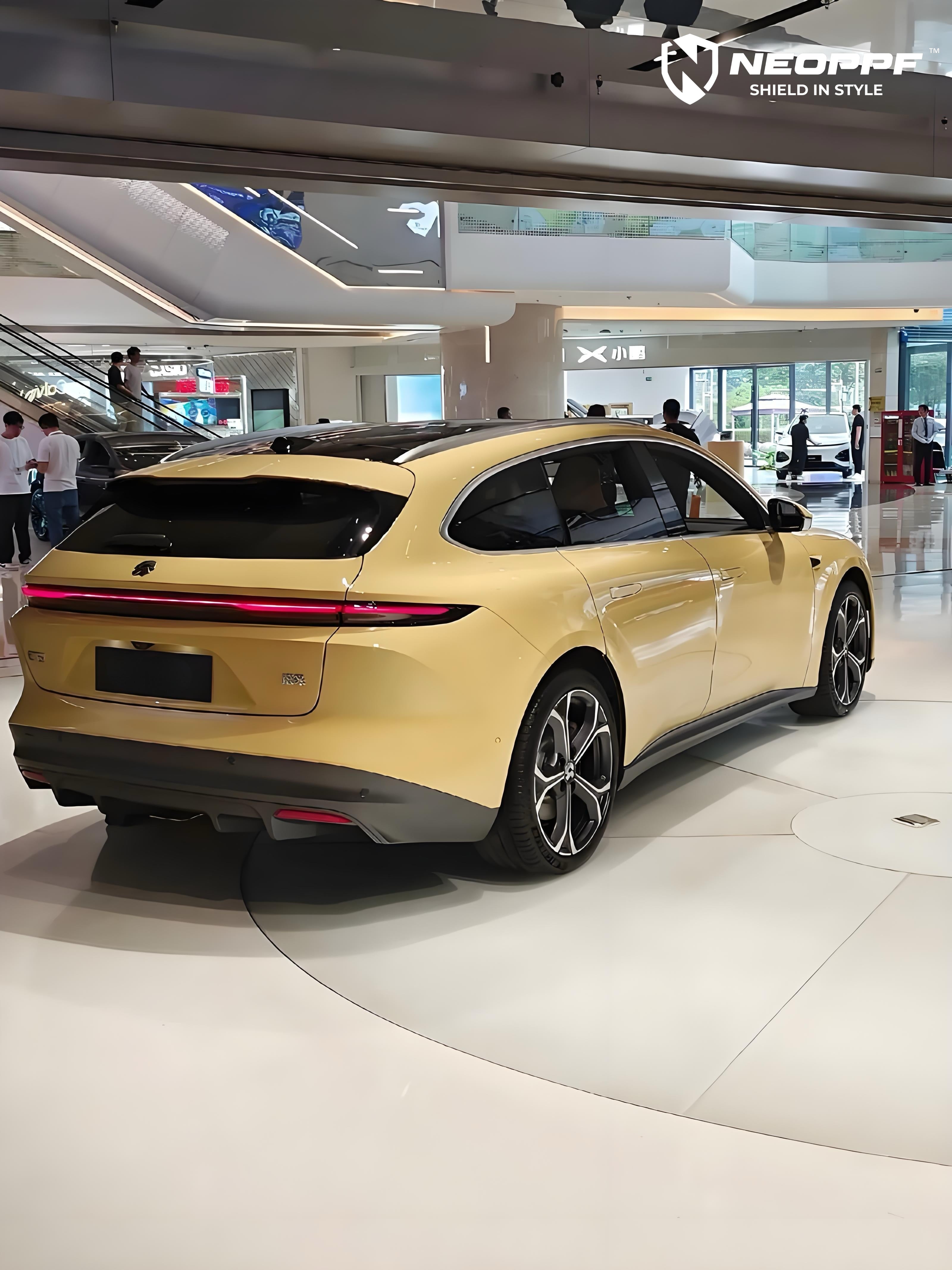 A sports car with Cream Yellow paint protection film colored wrap is parking in the garage