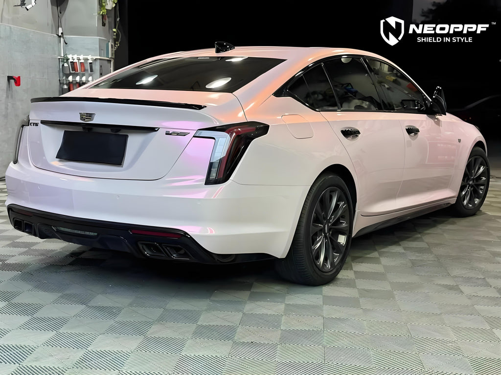 A sports car with Mary Kay Pink paint protection film colored wrap is parking in the garage