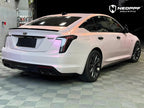 A sports car with Mary Kay Pink paint protection film colored wrap is parking in the garage