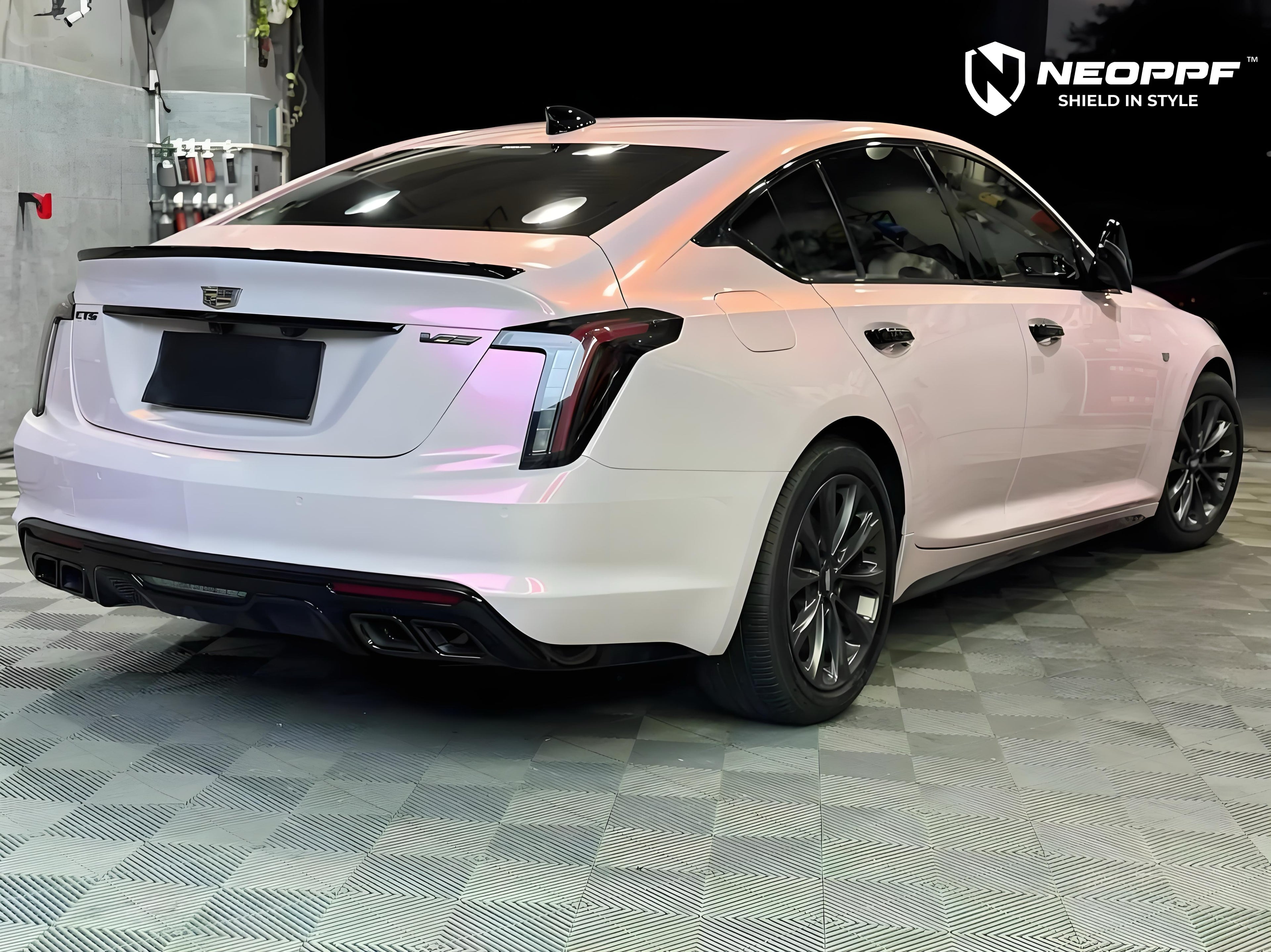 A sports car with Mary Kay Pink paint protection film colored wrap is parking in the garage