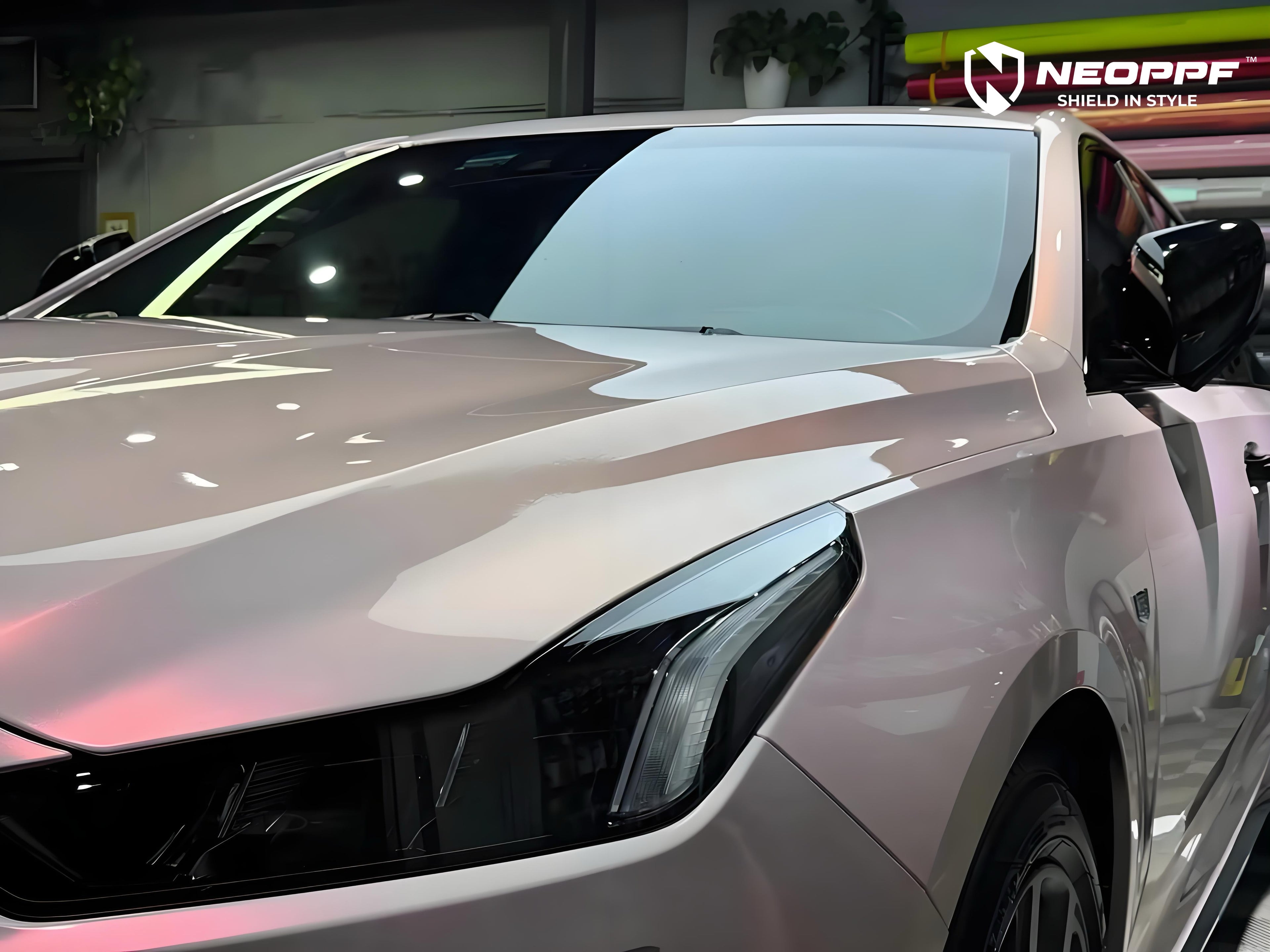 A sports car with Mary Kay Pink paint protection film colored wrap is parking in the garage