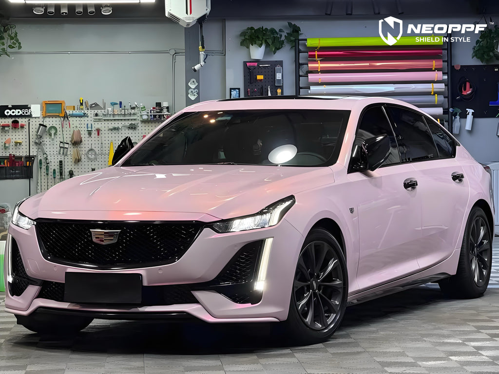 A sports car with Mary Kay Pink paint protection film colored wrap is parking in the garage