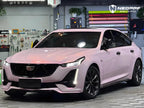 A sports car with Mary Kay Pink paint protection film colored wrap is parking in the garage