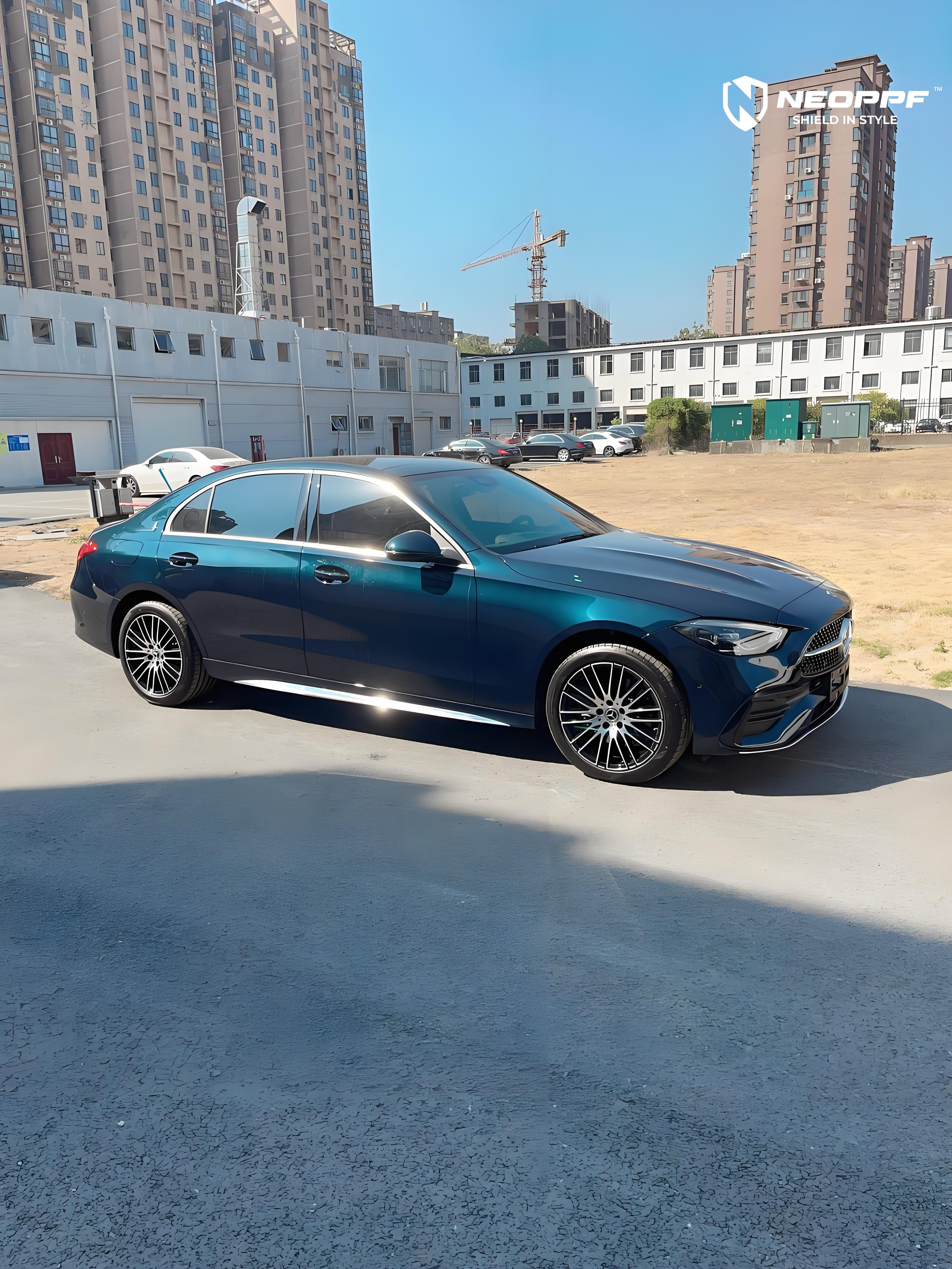 A sports car with Turquoise Green paint protection film colored wrap is parking in the garage