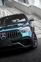 A sports car with Emerald Green Metallic paint protection film colored wrap is parking in the garage