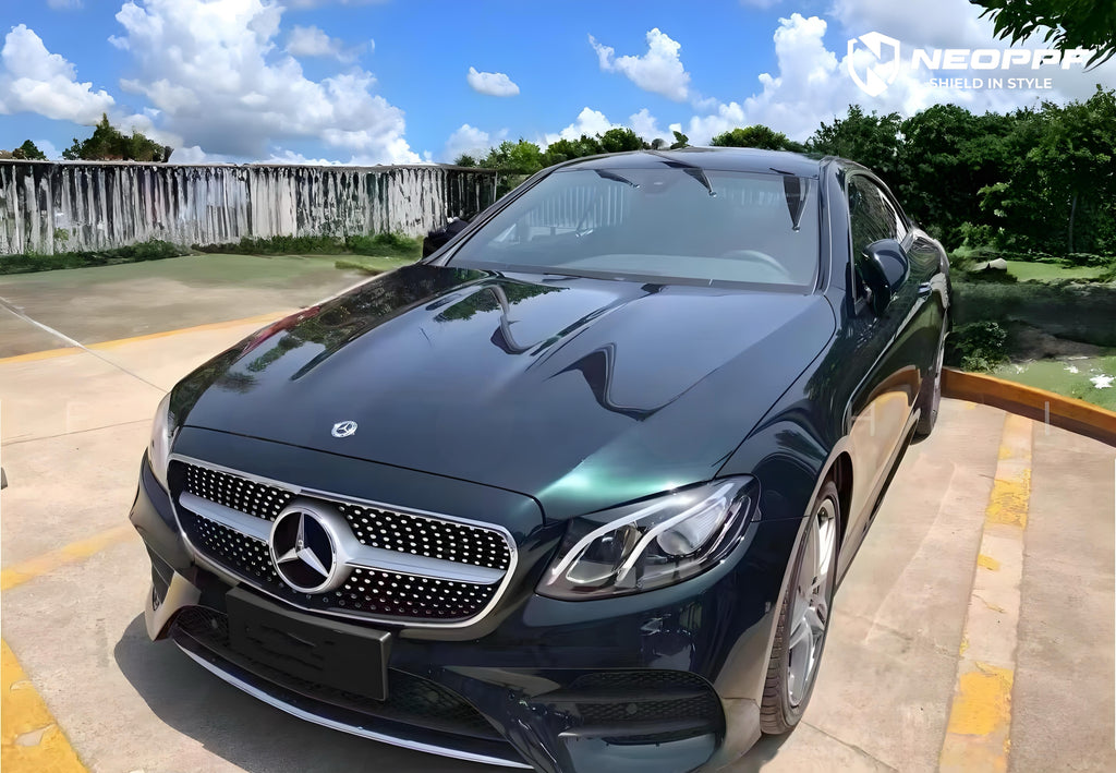 A sports car with Emerald Green Metallic paint protection film colored wrap is parking in the garage