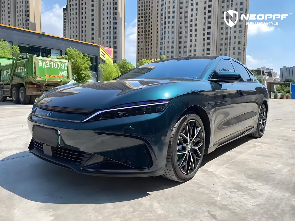 A sports car with Verdant Green paint protection film colored wrap is parking in the garage