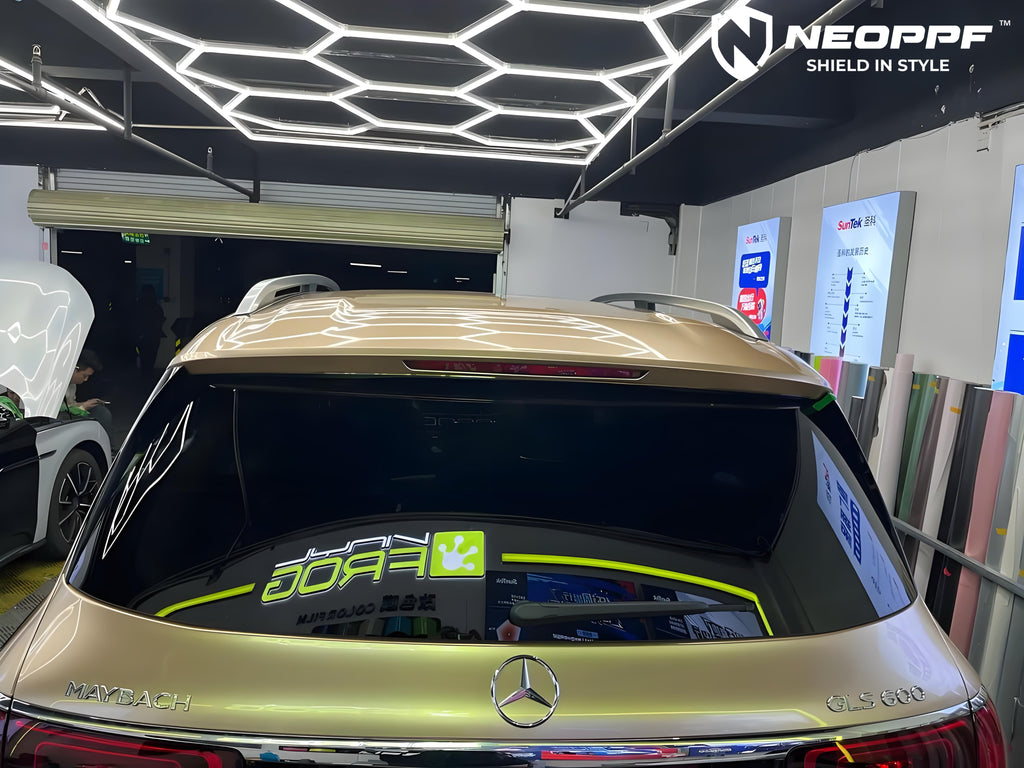 A sports car with Champagne Gold paint protection film colored wrap is parking in the garage