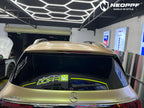 A sports car with Champagne Gold paint protection film colored wrap is parking in the garage