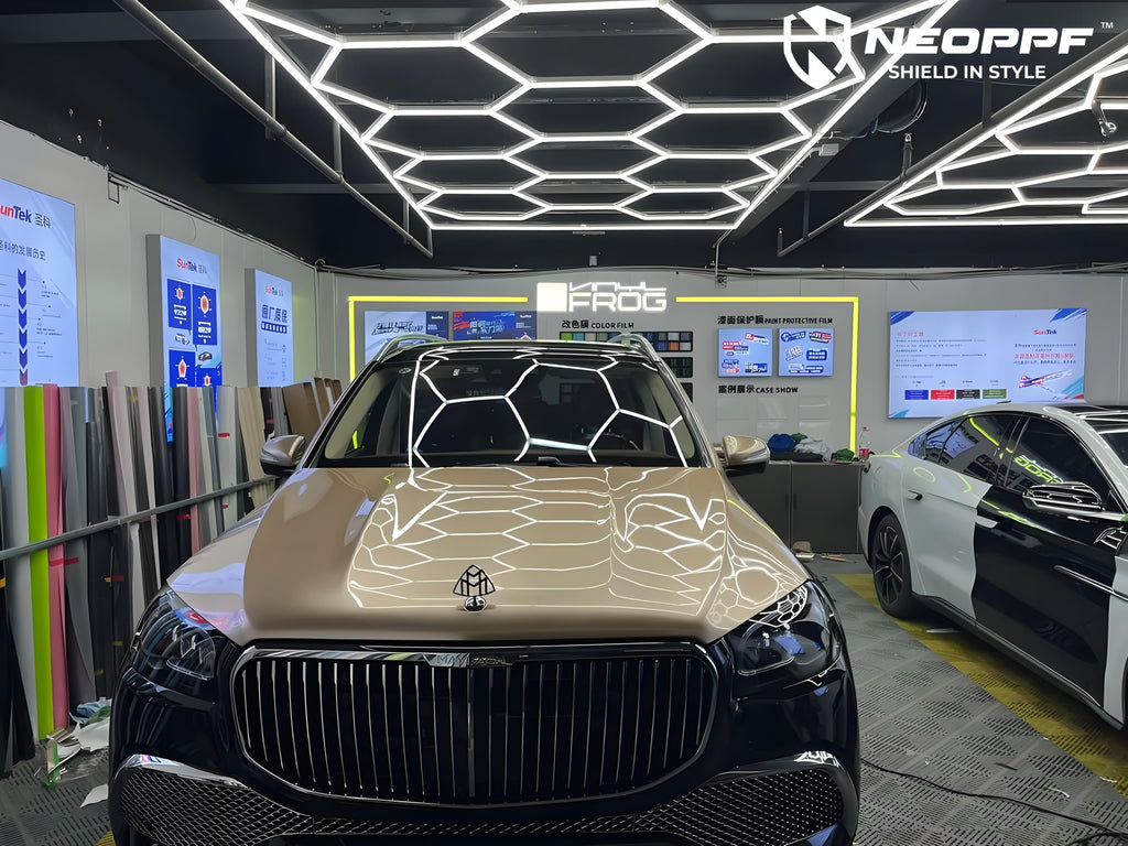 A sports car with Champagne Gold paint protection film colored wrap is parking in the garage