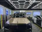 A sports car with Champagne Gold paint protection film colored wrap is parking in the garage